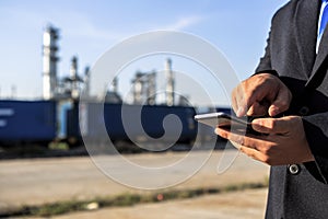 Businessman checking around oil refinery plant with clear sky