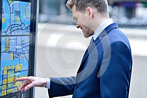 Businessman checking a bus timetable