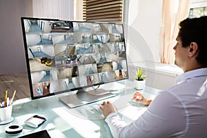 Businessman checking CCTV camera footage on computer