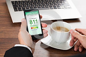 Businessman checking credit score on cellphone