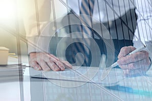 Businessman checking a document, light effect, double exposure