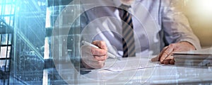 Businessman checking a document; multiple exposure