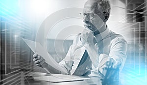 Businessman checking a document; multiple exposure