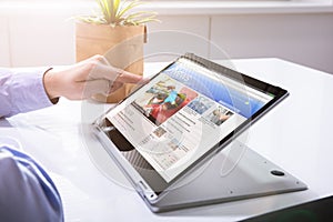 Businessman Checking Online News On Laptop