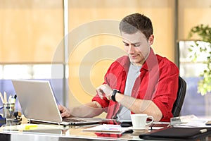 Businessman checking smart watch or clock