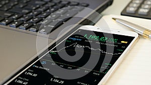 Businessman checking stock market dataà¸¡Stock Market Application for Mobile, Analyzing Data Stock Market on Mobile Young