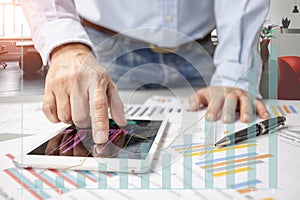 Businessman checking stock market data on tablet