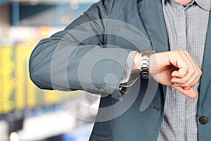 Businessman checking time on his watch at the airport.