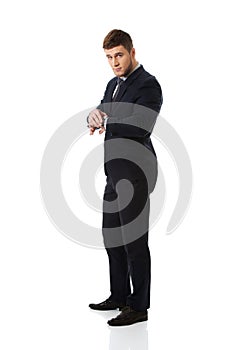 Businessman checking time on his wrist watch.