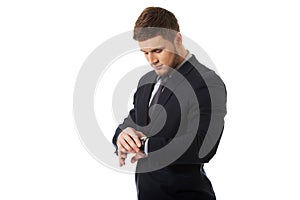 Businessman checking time on his wrist watch.