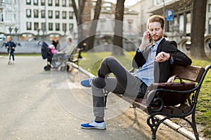 Businessman checking the time looking at his watch on a sunny da