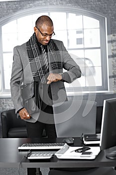 Businessman checking time at office