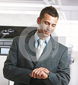 Businessman checking time in office