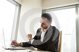 Businessman checks time left to important meeting