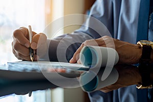 Businessman write and sign cheque