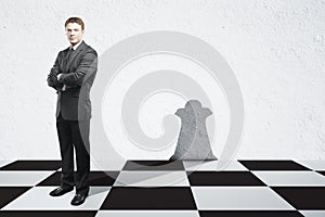Businessman with chess queen shadow