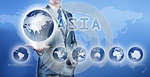 Businessman choosing asia continent on virtual digital screen