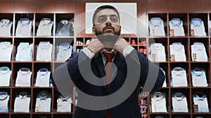 Businessman choosing classical suit in the suit shop