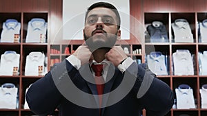 Businessman choosing classical suit in the suit shop