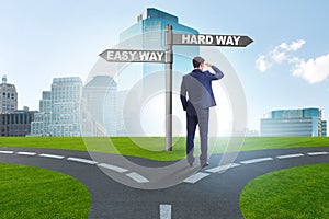 The businessman choosing between hard and easy way