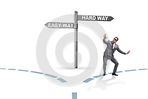 The businessman choosing between hard and easy way