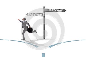 Businessman choosing between hard and easy way