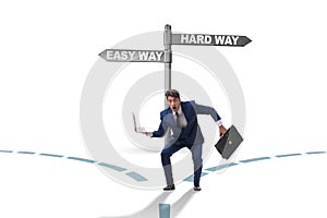 Businessman choosing between hard and easy way