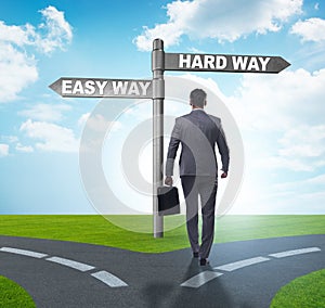 Businessman choosing between hard and easy way