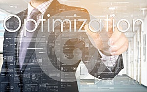 The businessman is choosing Optimization from touch screen