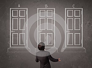 Businessman choosing the right door