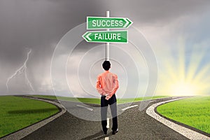 Businessman choosing success or failure road