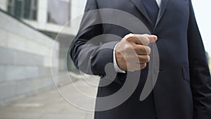 Businessman clenching fist after successful job interview, proud of result