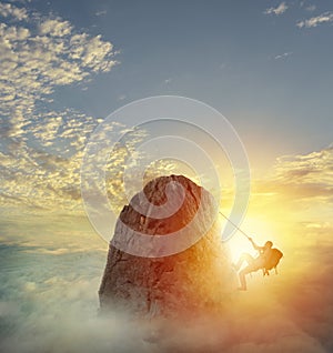 Businessman climb a mountain to get the flag. Achievement business goal and difficult career concept photo