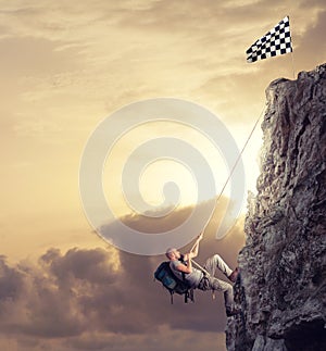 Businessman climb a mountain to get the flag. Achievement business goal and difficult career concept photo