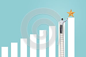 Businessman climb up rising graph on ladder to reach star, successful and win concept