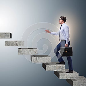 Businessman climbing career ladder in business concept