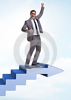 Businessman climbing career ladder in business concept