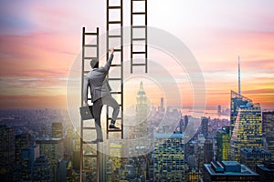 The businessman climbing career ladder in business concept