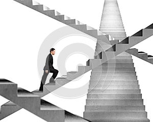 Businessman climbing on concrete stair maze