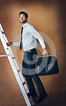 Businessman, climbing and corporate ladder in studio for work opportunity, promotion and high salary. Confident, male