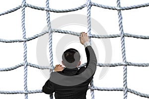 Businessman climbing crisscross rope net isolated on white