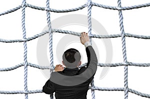 Businessman climbing crisscross rope net isolated on white photo