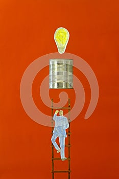 Businessman climbing ladder up to a lightbulb, thinking outside the box,idea,success,human resources, innovation concept