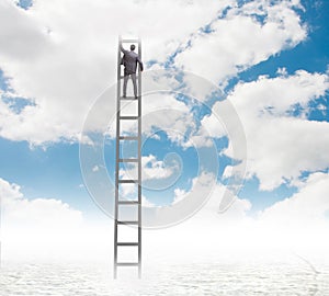 Businessman climbing stairs against the sky