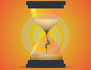 Businessman climbing up sand in hourglass. Concept losing time