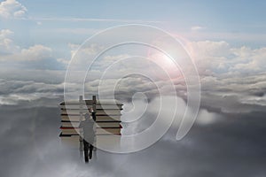 Businessman climbing on wooden ladder to top of books