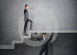 Businessman climbs the concrete stairs, which the other person keeps.