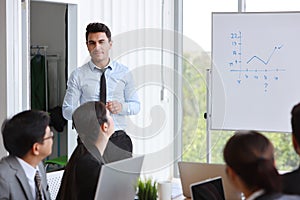 Businessman coaching in team meeting or training, speaker drawing graph on white board business seminar concept