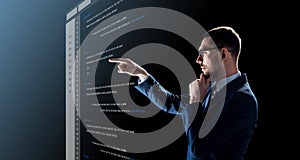 Businessman with coding on virtual screen