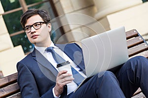 Businessman with coffee and laptop